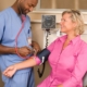 Healthcare worker in scrubs checking a patient blood pressure in a clinic