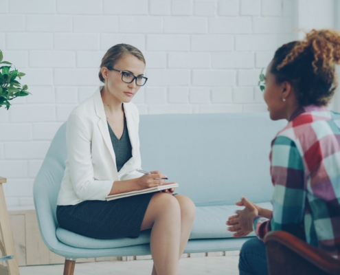Two women talking during a therapy session for panic disorder management