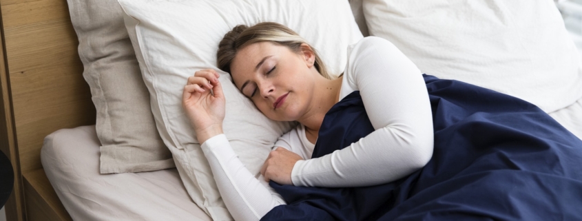 Person sleeping restfully in bed, illustrating sleep restoration in residential mental health care