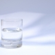 A clear glass of water on a white table in soft natural light