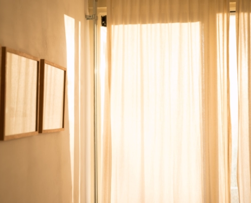 Warm daylight filtering through sheer curtains in a calm, private room, representing confidentiality in residential mental health treatment