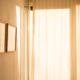 Warm daylight filtering through sheer curtains in a calm, private room, representing confidentiality in residential mental health treatment