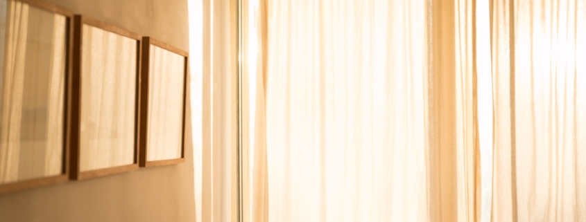 Warm daylight filtering through sheer curtains in a calm, private room, representing confidentiality in residential mental health treatment