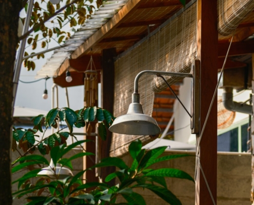 A sheltered outdoor patio with a warm lamp and green plants, suggesting a calm place to think through where to turn for mental health help