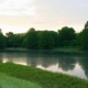 Calm lake at morning with mist and trees reflected on still water