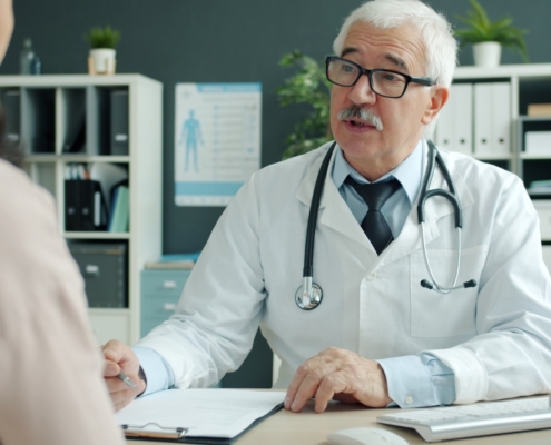 Psychiatrist reviewing an Internal Family Systems treatment plan with a client during a residential mental health program consultation
