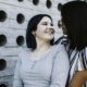 Two adults sitting together outdoors in a calm, supportive conversation