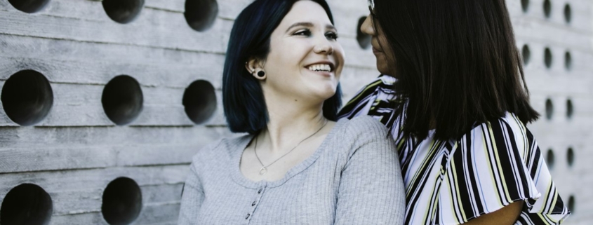 Two adults sitting together outdoors in a calm, supportive conversation