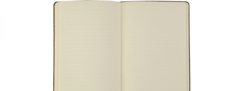 An open blank notebook with a pen resting above it, ready for writing down treatment preferences