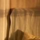 Warm morning light across bed linen representing restored sleep in residential care