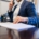 Person on the phone with plan documents in front of them, verifying insurance coverage for residential mental health treatment