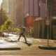 A person with a backpack walking across a quiet city street in early morning light on the way to work